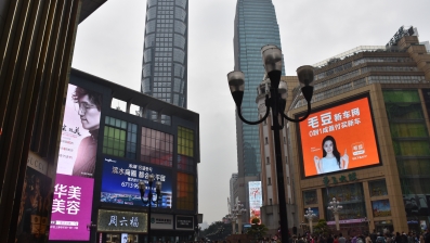 Associate Professor Ian McArthur is exploring the use of urban screens in Chongqing, China. Jiefangbei CBD, its central business district, centred on a large pedestrian mall surrounded by skyscrapers. Photo: Ian McArthur